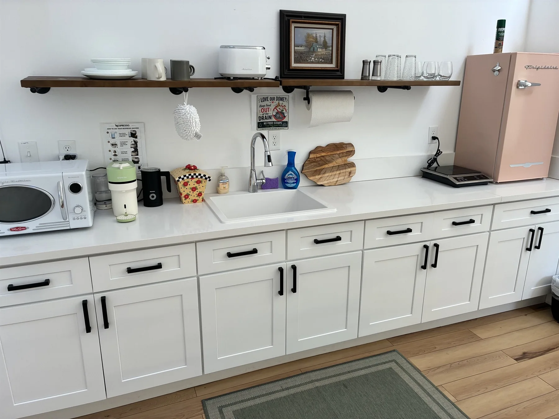 Wide view of the white kitchenette