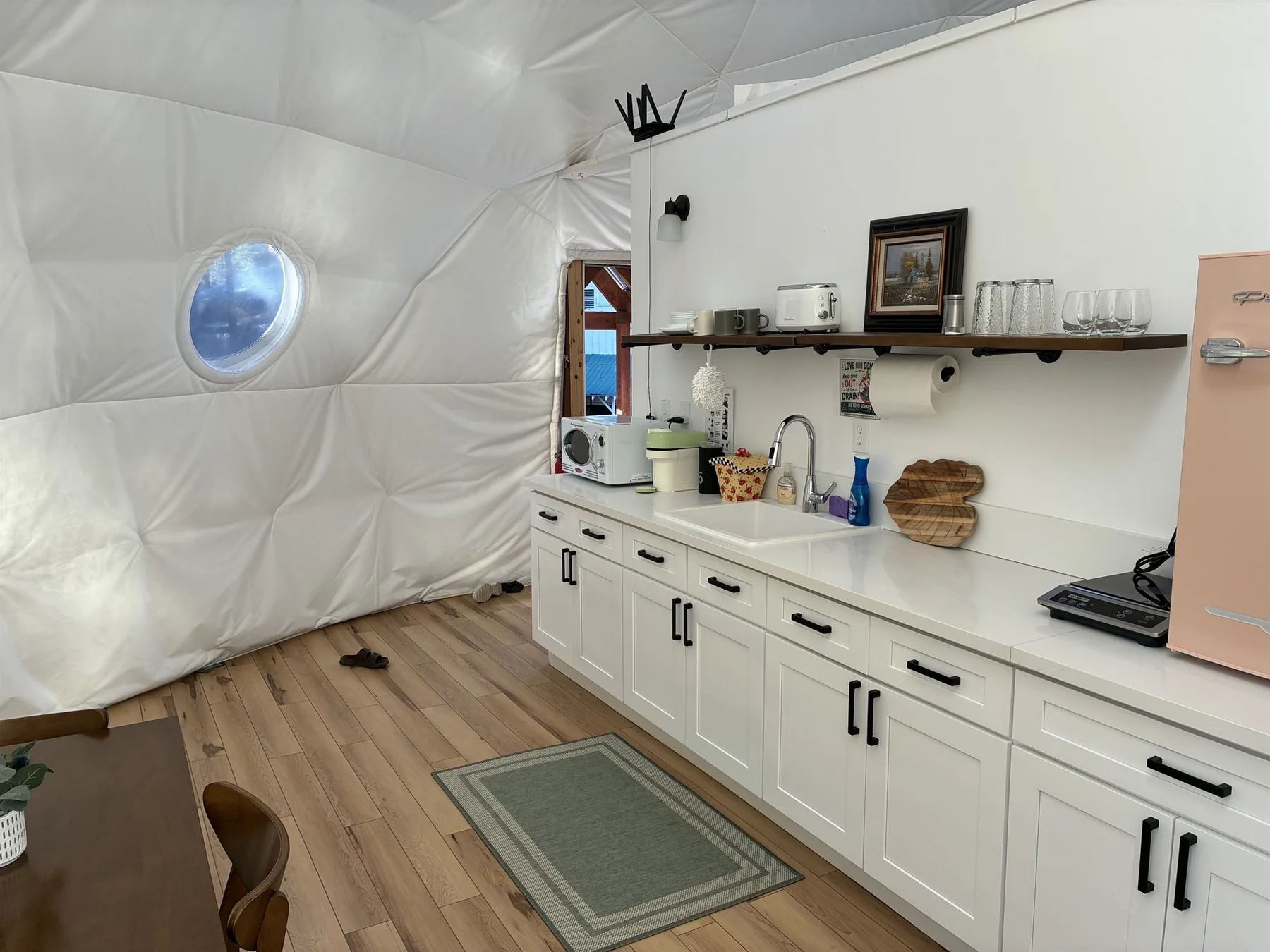 Kitchenette with counter, refrigerator, microwave and supplies