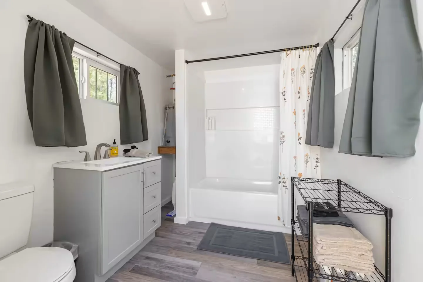 Private bathroom with vanity, toilet, and tub-shower