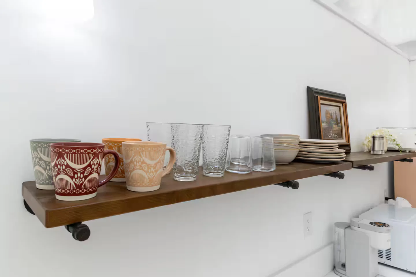Mugs and glassware on the kitchenette shelf