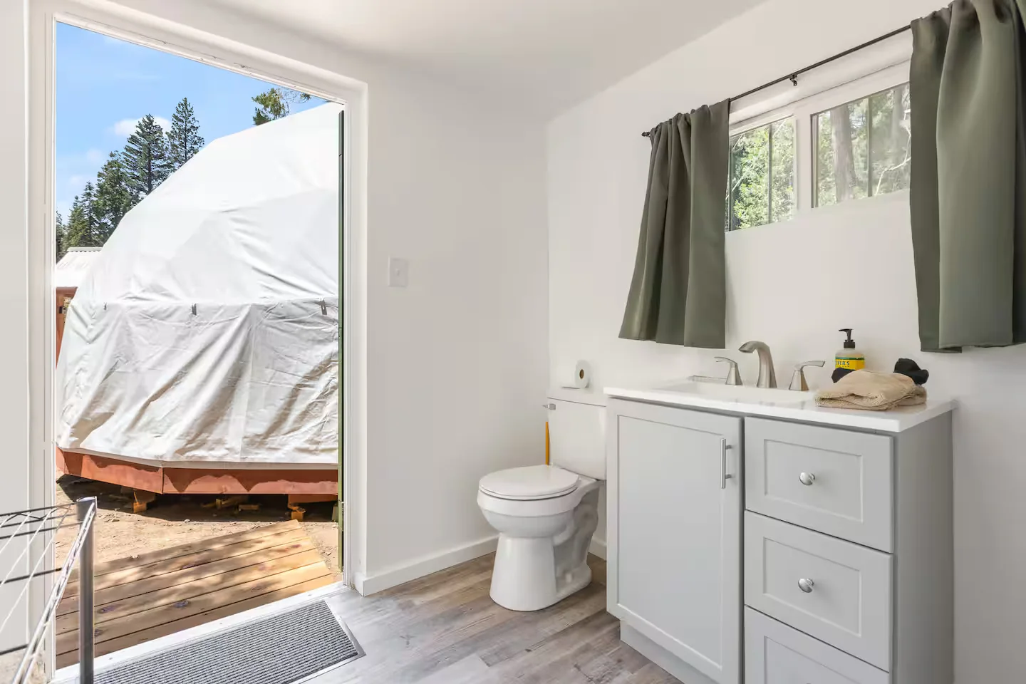 Bathroom vanity and toilet with the dome visible outside
