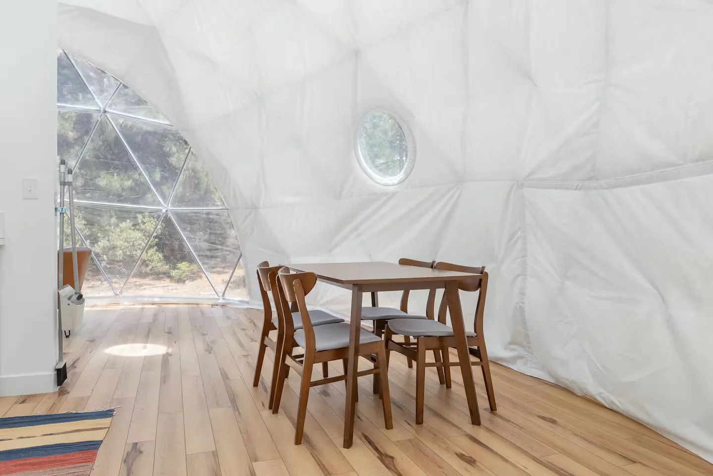Dining table beside the clear forest-facing dome wall